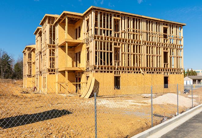 a temporary chain link fence in front of a building under construction, ensuring public safety in San Fernando CA